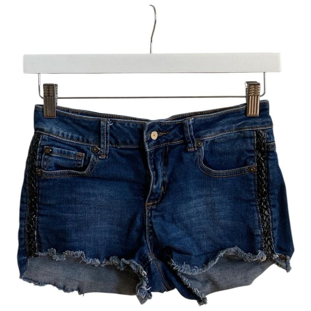 Blue denim shorts with black lace trim on sides and frayed hem